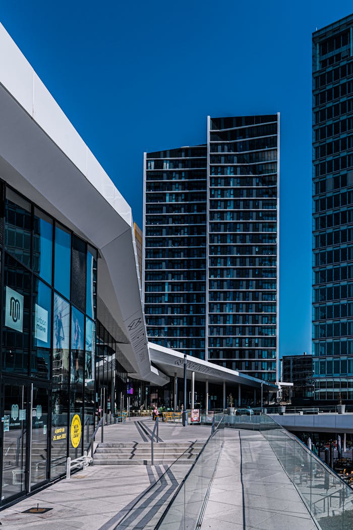 Contemporary urban architecture in Luxembourg with sleek glass facades and blue sky.